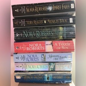 7 paperbacks. 6 Nora Roberts and one Pat Conroy